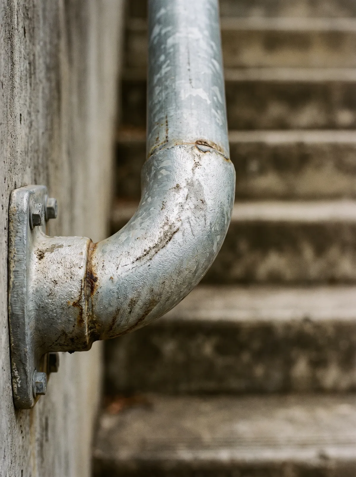 Close-up of a galvanised steel pipe handrail bend